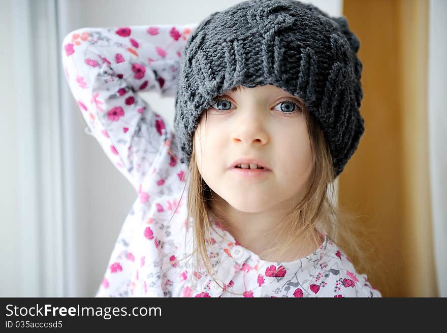 Adorable little girl in grey knit hat