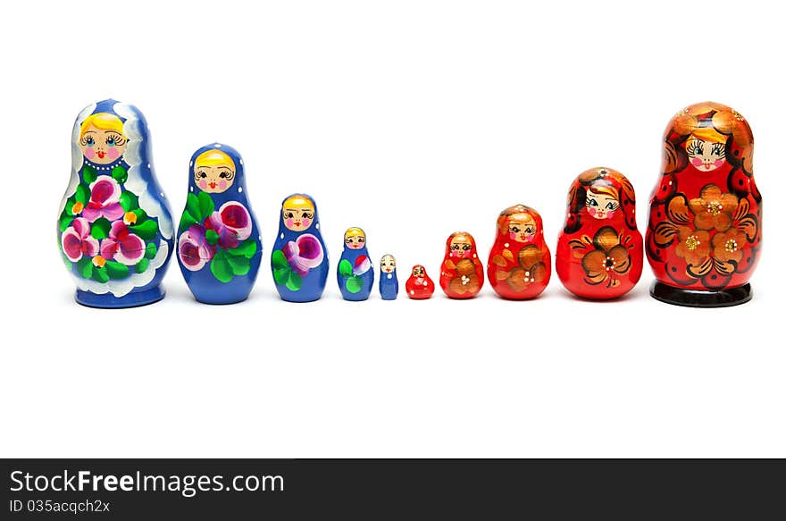 Russian nesting dolls stand in a row on a white background