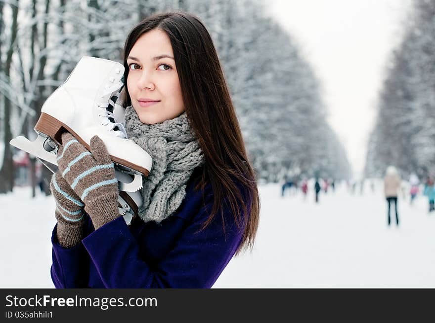 Attractive brunette young woman on the ice rink