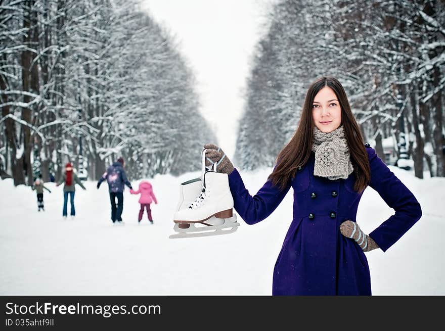 Attractive brunette young woman on the ice rink