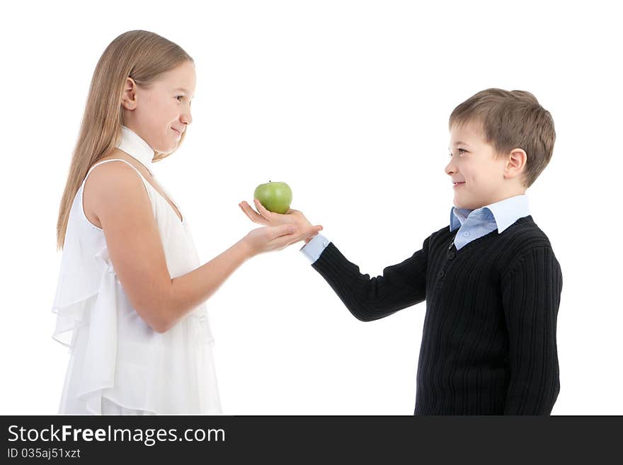 The boy gives to the girl an apple on a white background