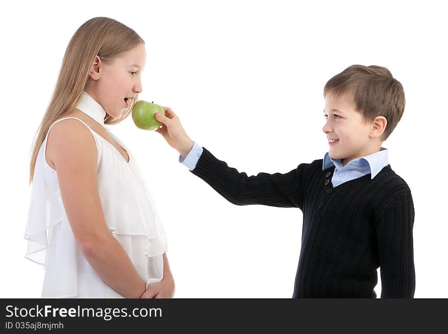 The boy gives to the girl an apple on a white background