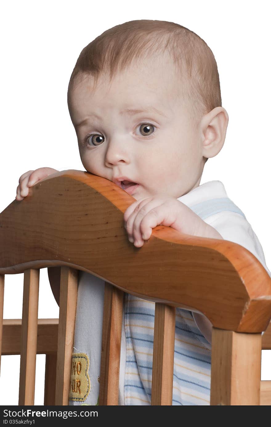 Little baby boy standing in the crib