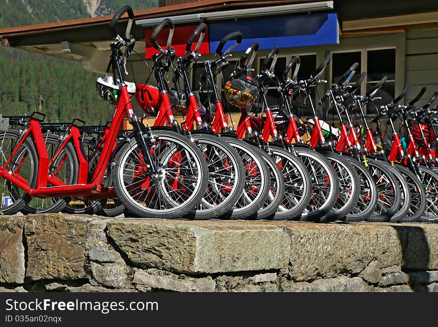 Many red downhill bicycles for rent at the swiss railway station