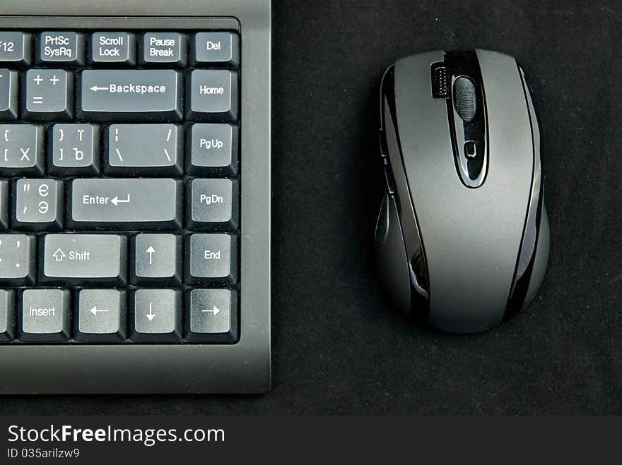 Black pc keyboard and mouse on black background. Black pc keyboard and mouse on black background