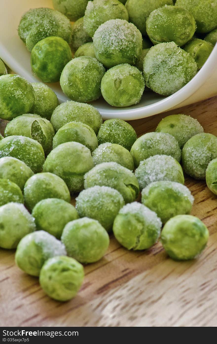 Peas with ice out of a container. Great colors