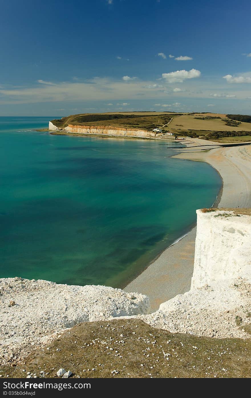 Bay at the foot of Seven Sisters, white chalk cliffs in East Sussex, United Kingdom. Bay at the foot of Seven Sisters, white chalk cliffs in East Sussex, United Kingdom.