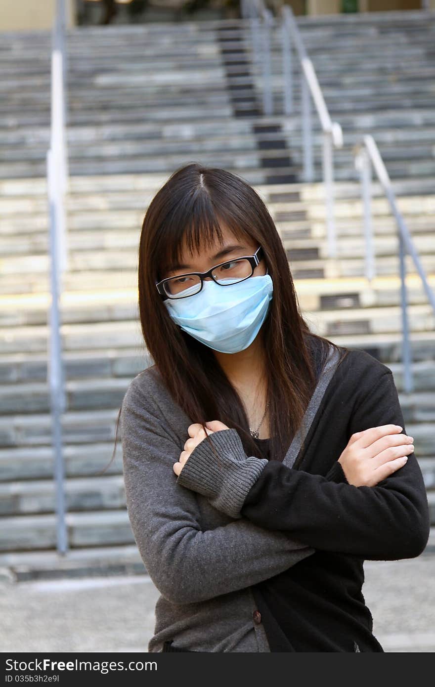 Asian girl who is sick and wearing mask