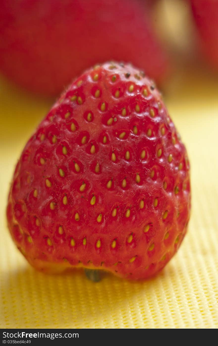 Strawberry close up on a yellow napkin