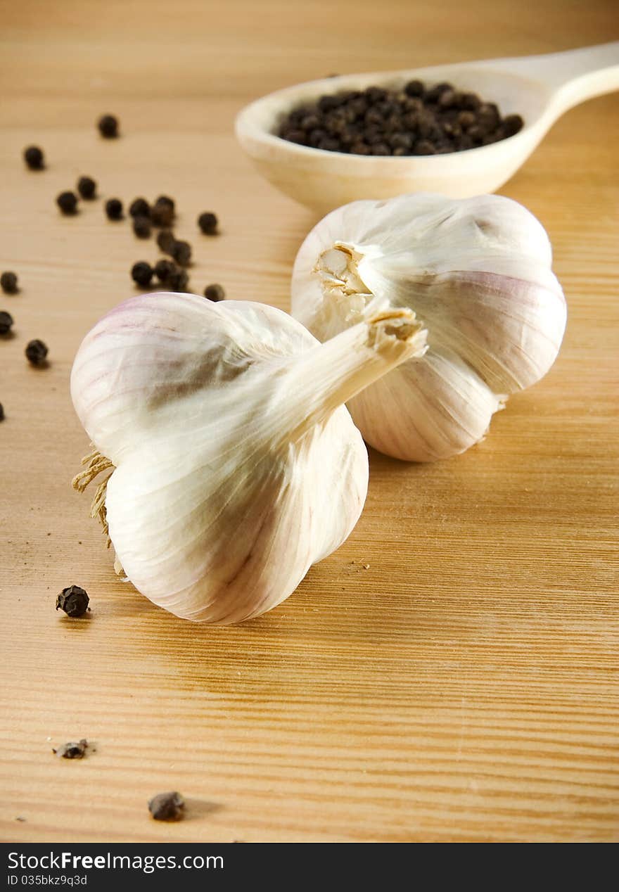 Garlic And Pepper On Wooden Spoon