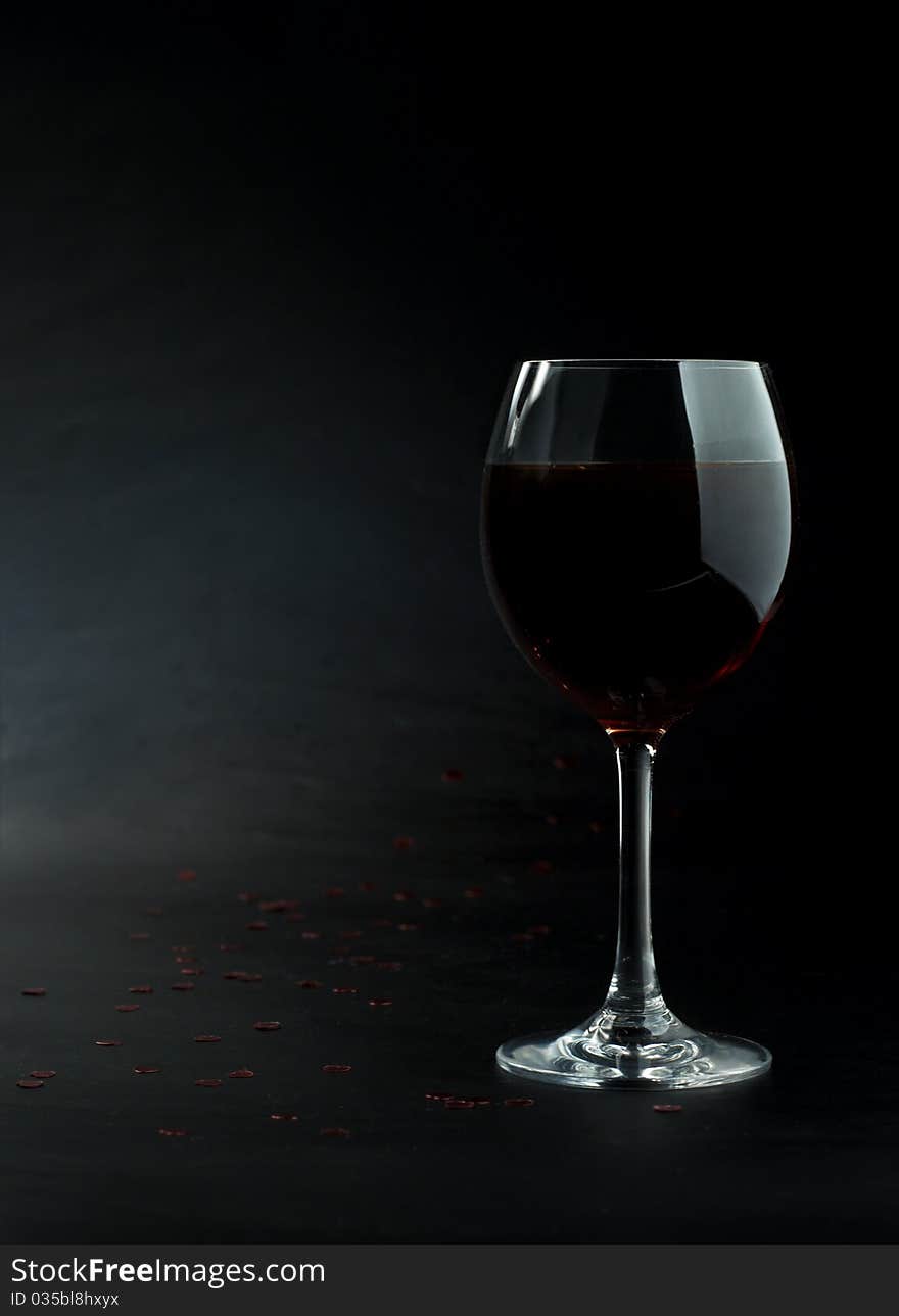 Glass of red wine on a dark background