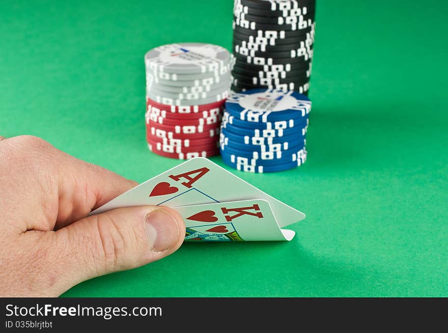 ace king with poker chips on a green poker baize