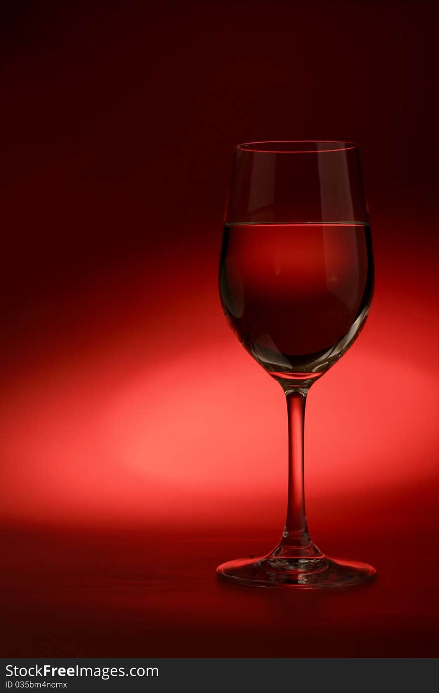 Glass of white wine on a dark background