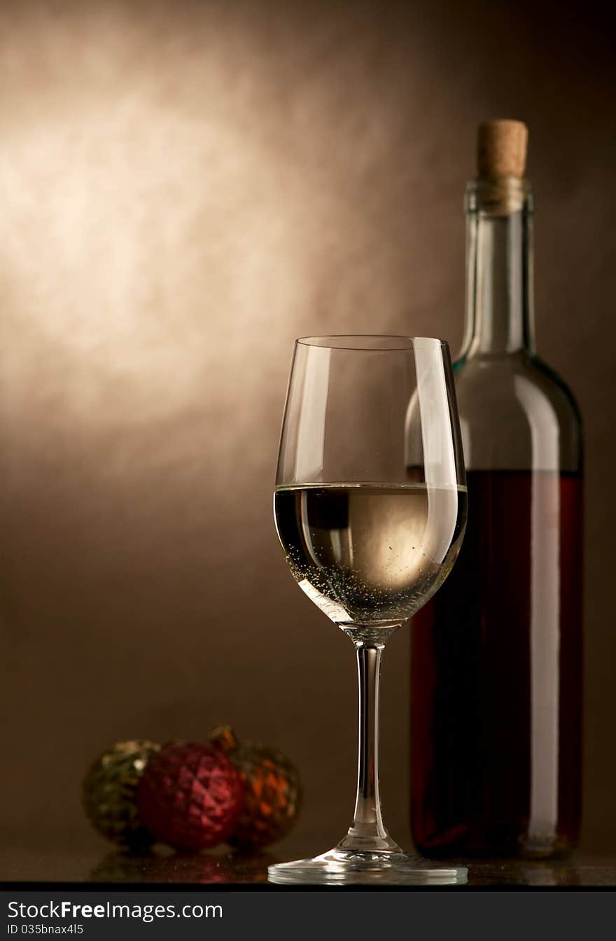 Bottle and glass of wine on a dark background