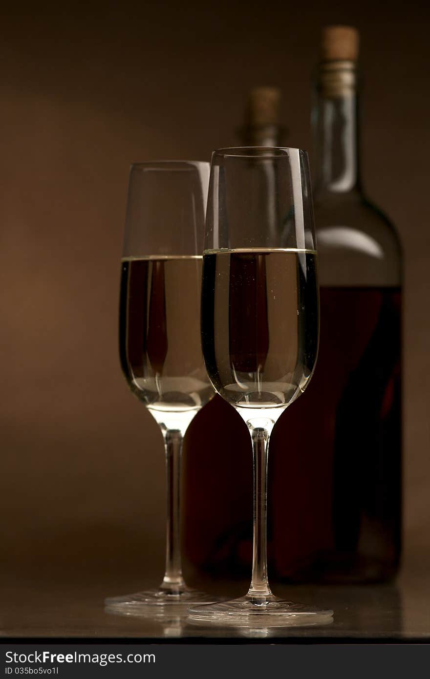 Bottle and glass of wine on a dark background