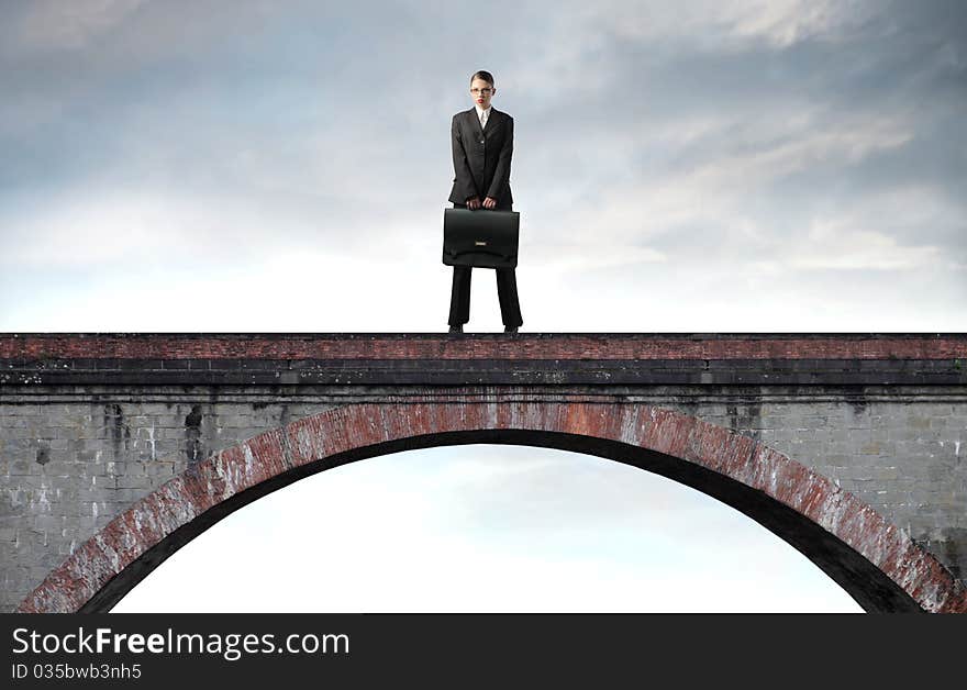 Businesswoman standing on a bridge. Businesswoman standing on a bridge