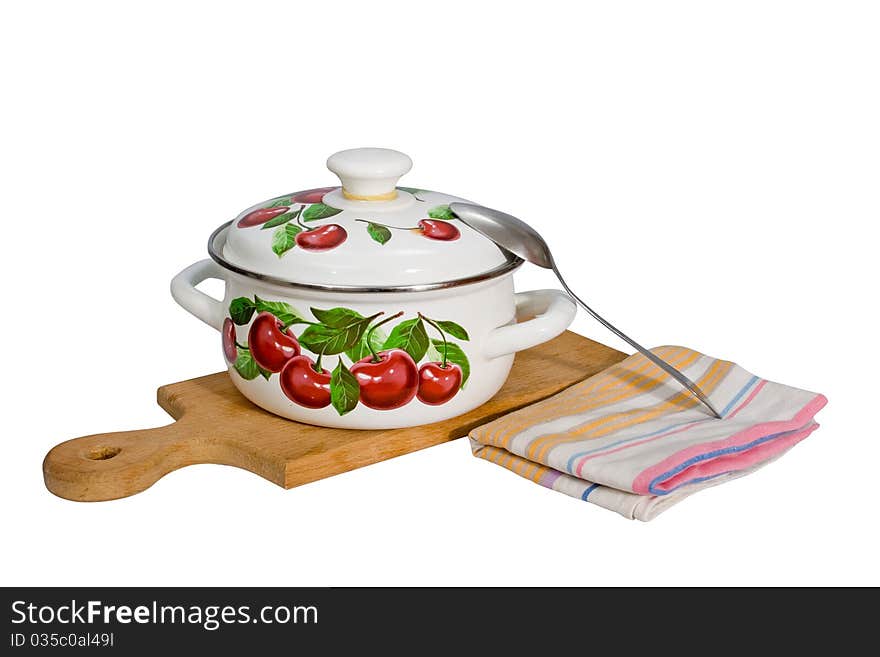 A metal pan and kitchen utensils on a cutting board.