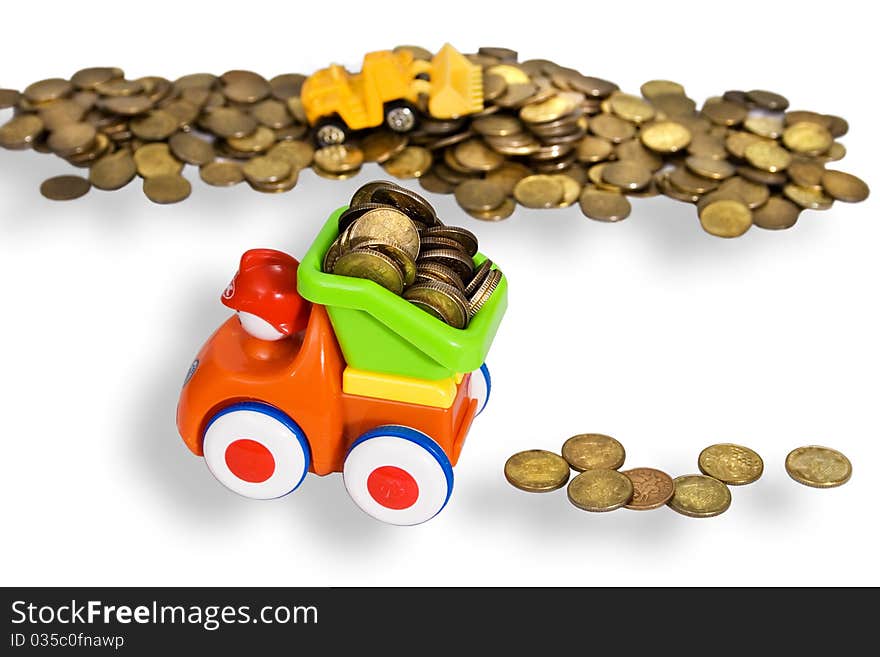 Gold coins are produced and transported with toy cars. white background. Gold coins are produced and transported with toy cars. white background.