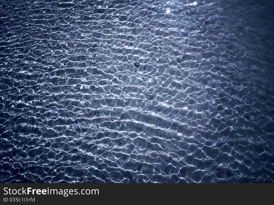 Beach pebbles under clear water with waves. Beach pebbles under clear water with waves