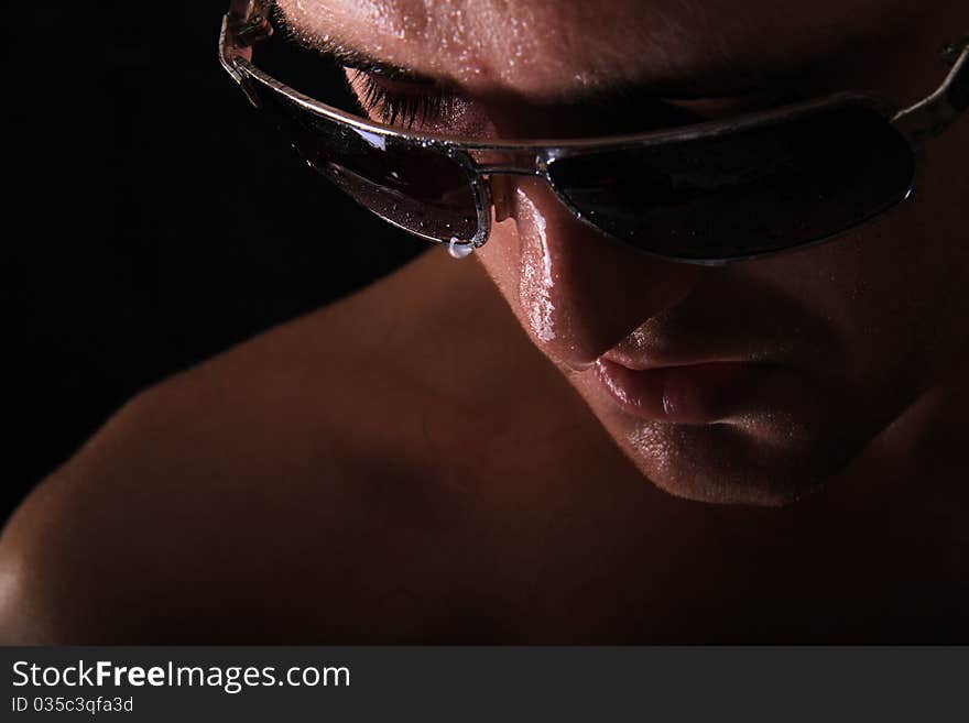 Model wearing glasses with water dripping from them. Model wearing glasses with water dripping from them