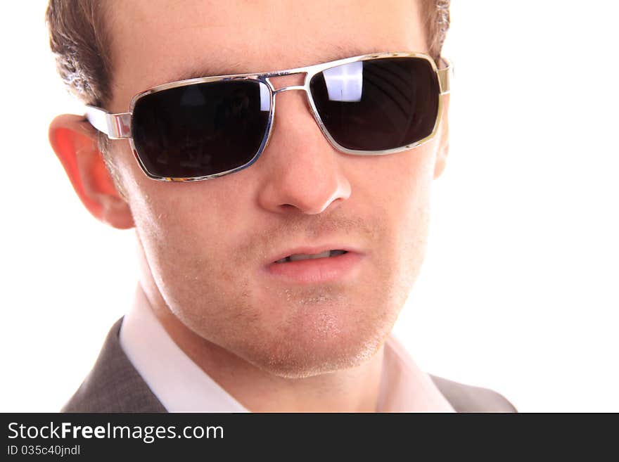 Serious close up of a business man against a white background. Serious close up of a business man against a white background