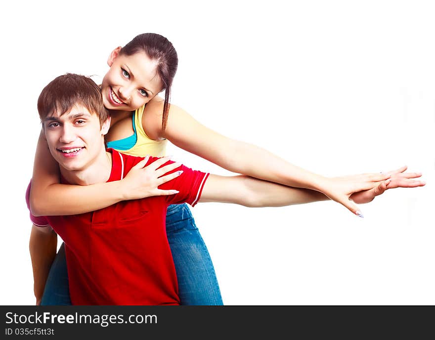 Happy excited teenage couple, a boy giving a piggyback ride to his girlfriend (focus on the boy)