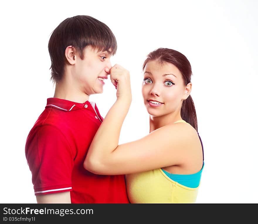 Teenage couple fooling around, a girl pulling a boy by the nose