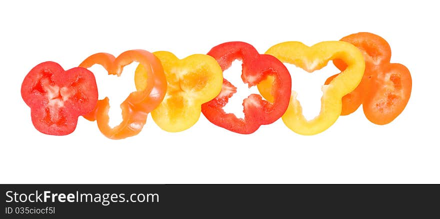 Pepper rings in yellow red orange colors on thw white background