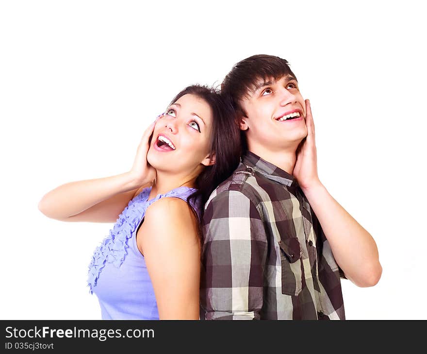 Beautiful surprised teenage couple looking up