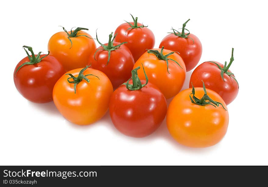 Yellow and red tomatoes in a group on the white background