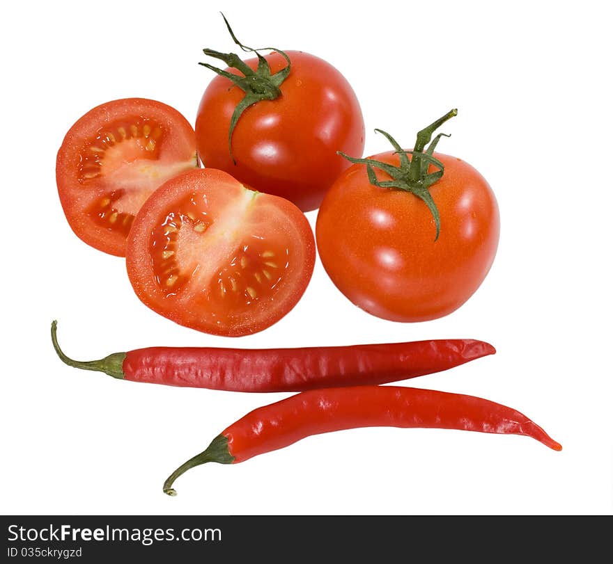 Red tomatoes with chilly peppers isolated on the white