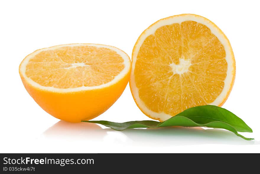 Two halfs of cropped orange with green leaves. Two halfs of cropped orange with green leaves