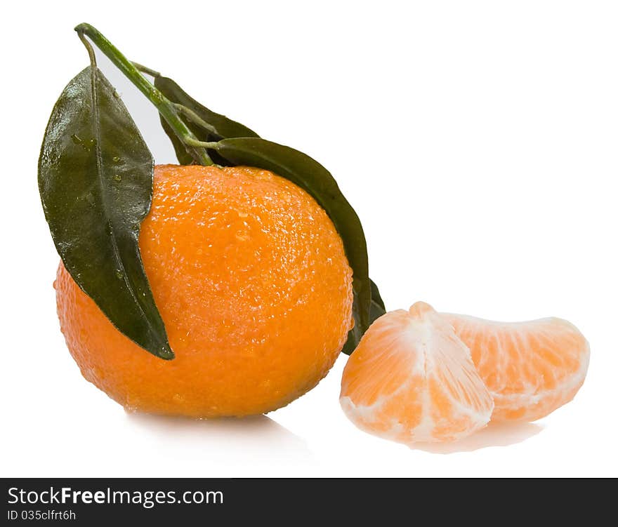 Fresh mandarin with drops of water and two segments