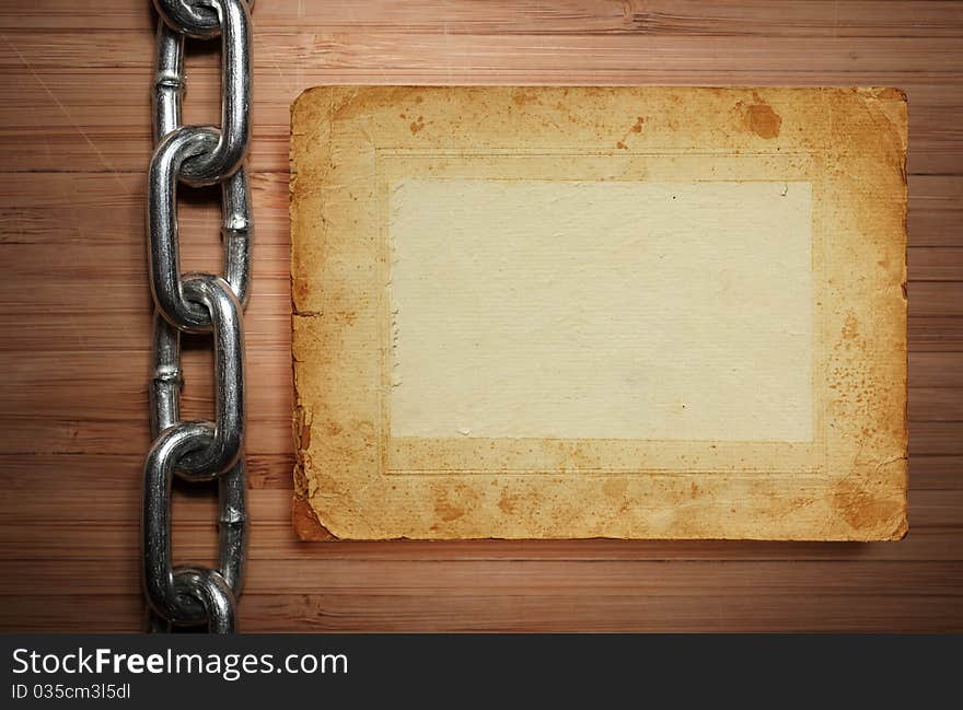 A old paper on wooden desks with chain as a background or texture on white