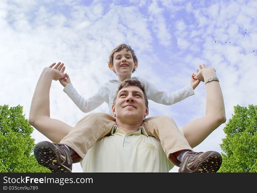 Father and son against the cloudy sky