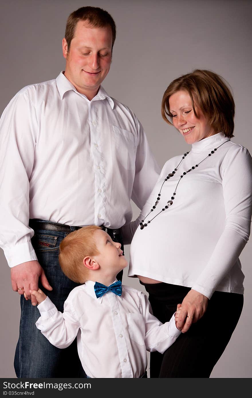 Happy family with cute boy expecting another baby