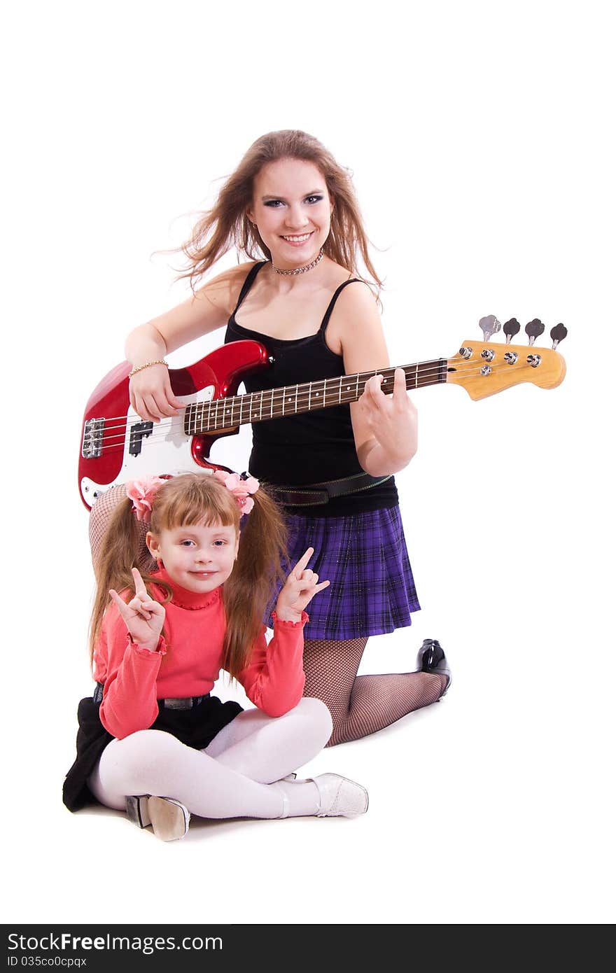 Teenage Rockstar. Teenager girl playing a bass guitar isolated on white. Teenage Rockstar. Teenager girl playing a bass guitar isolated on white.