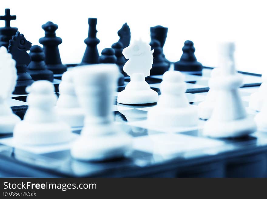 Composition with chessmen on a white background (selective focus)