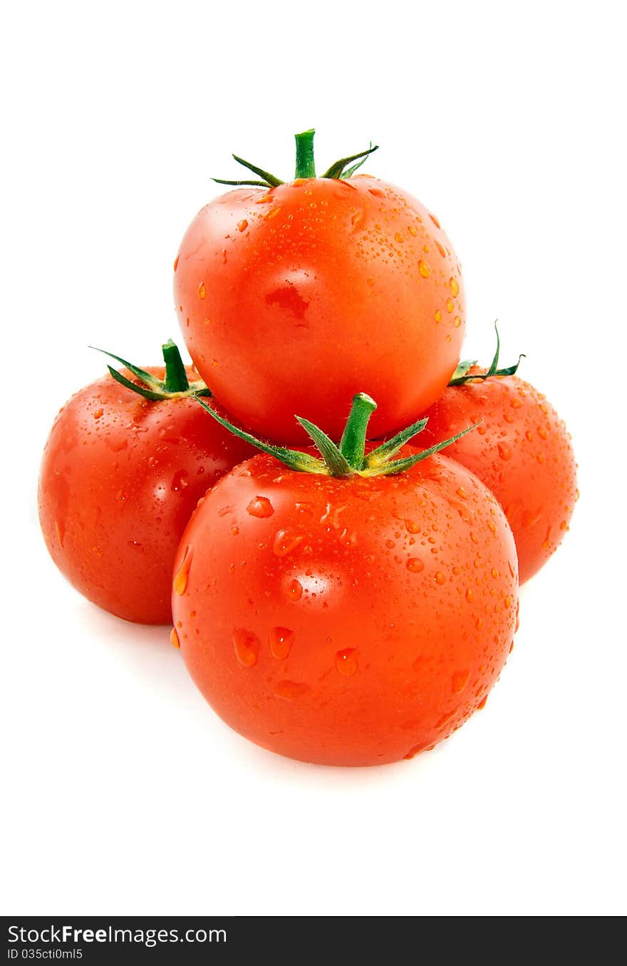 Pyramid of the four red and moist tomatoes on a white background. Pyramid of the four red and moist tomatoes on a white background