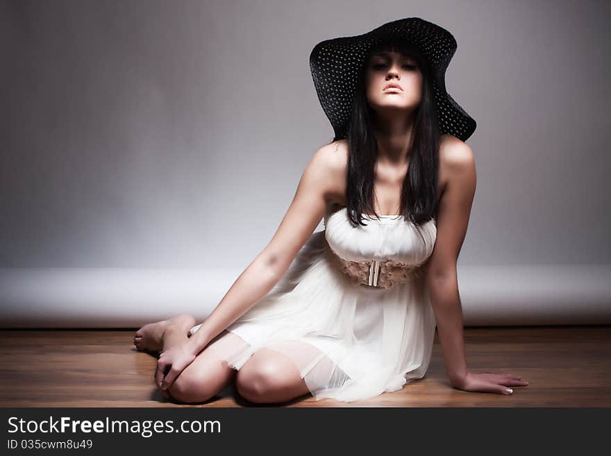 Beautiful young attractive woman posing in a hat