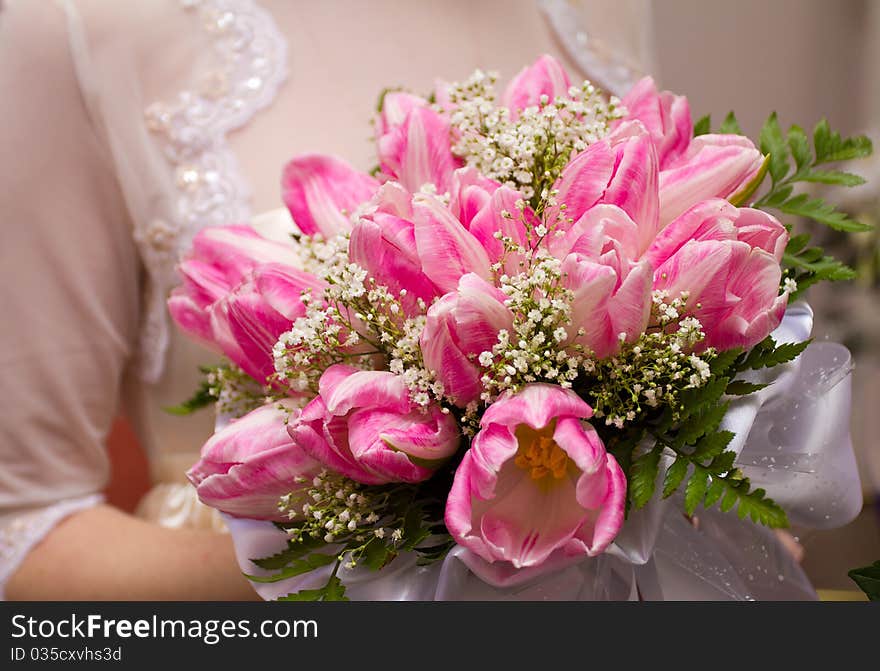 Wedding bouquet in hands of bride