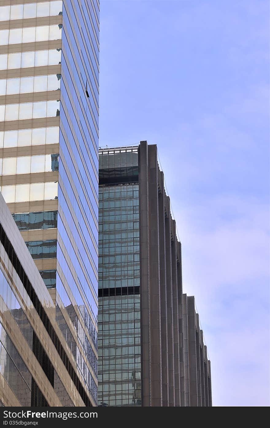 Modern buildings in Hongkong, under blue sky, with glass external and reflection, means business developing and urban environment. Modern buildings in Hongkong, under blue sky, with glass external and reflection, means business developing and urban environment.