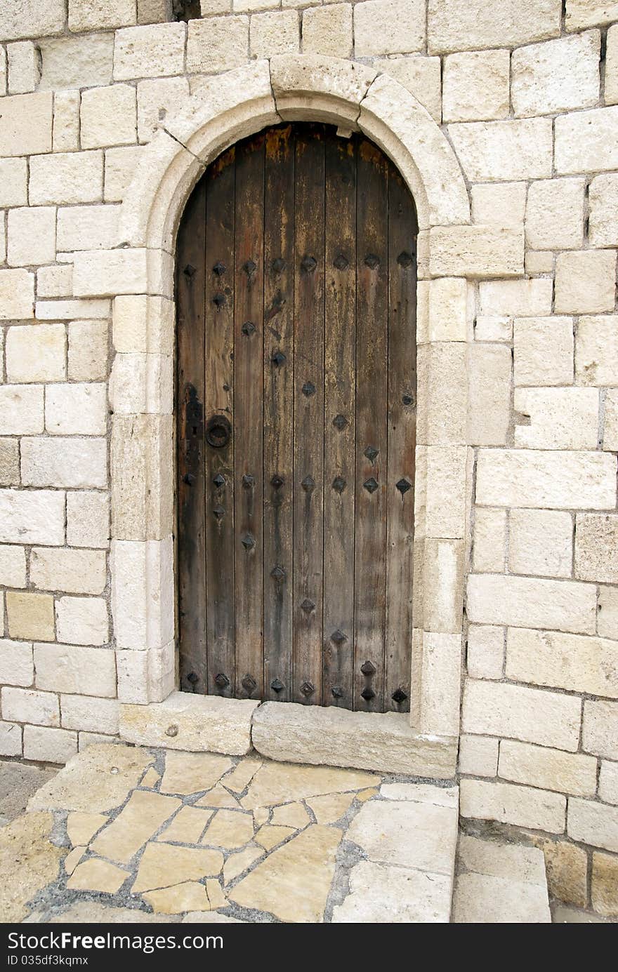 Brown door on the background of a white wall