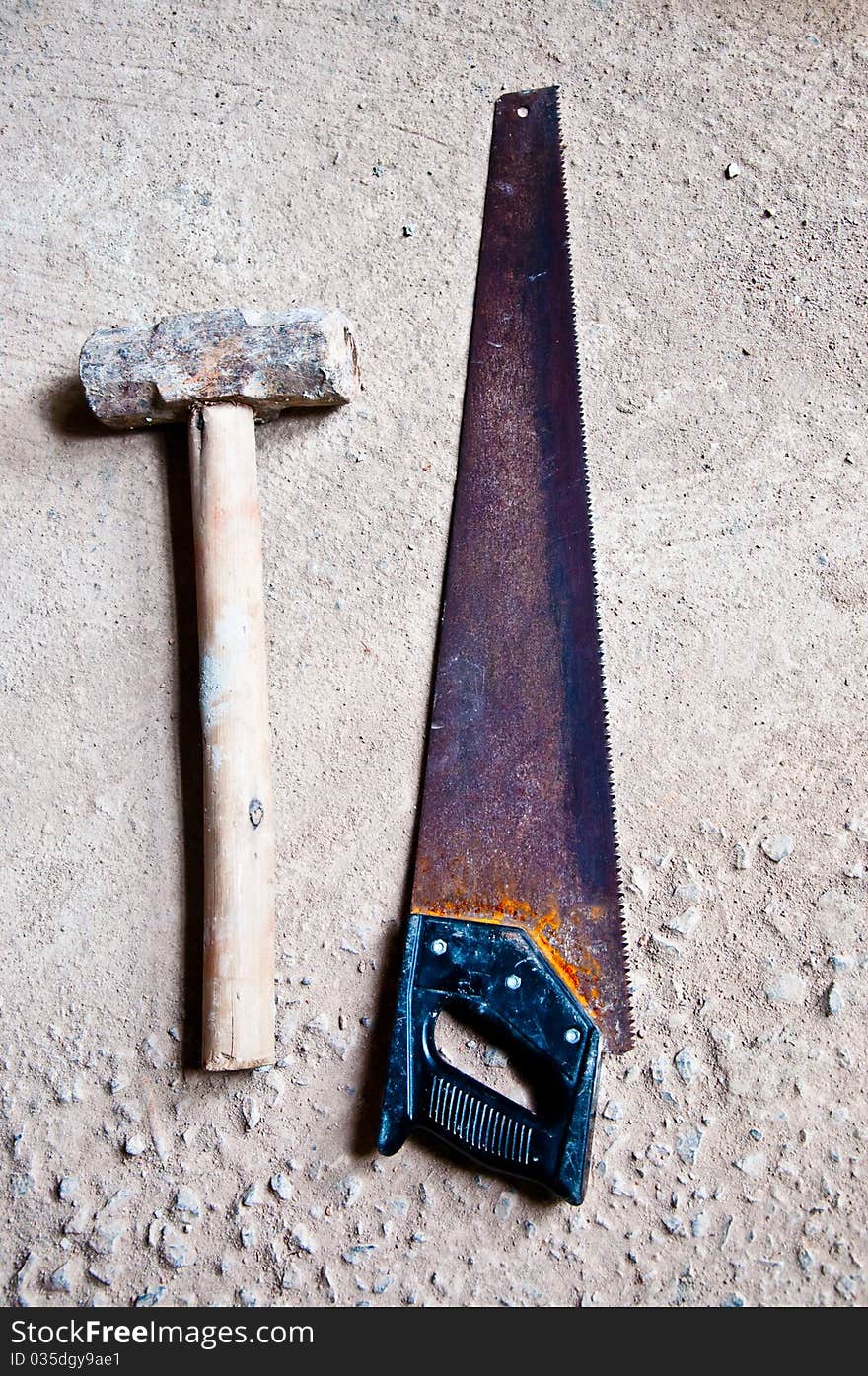 The Hammer with saw on cement floor