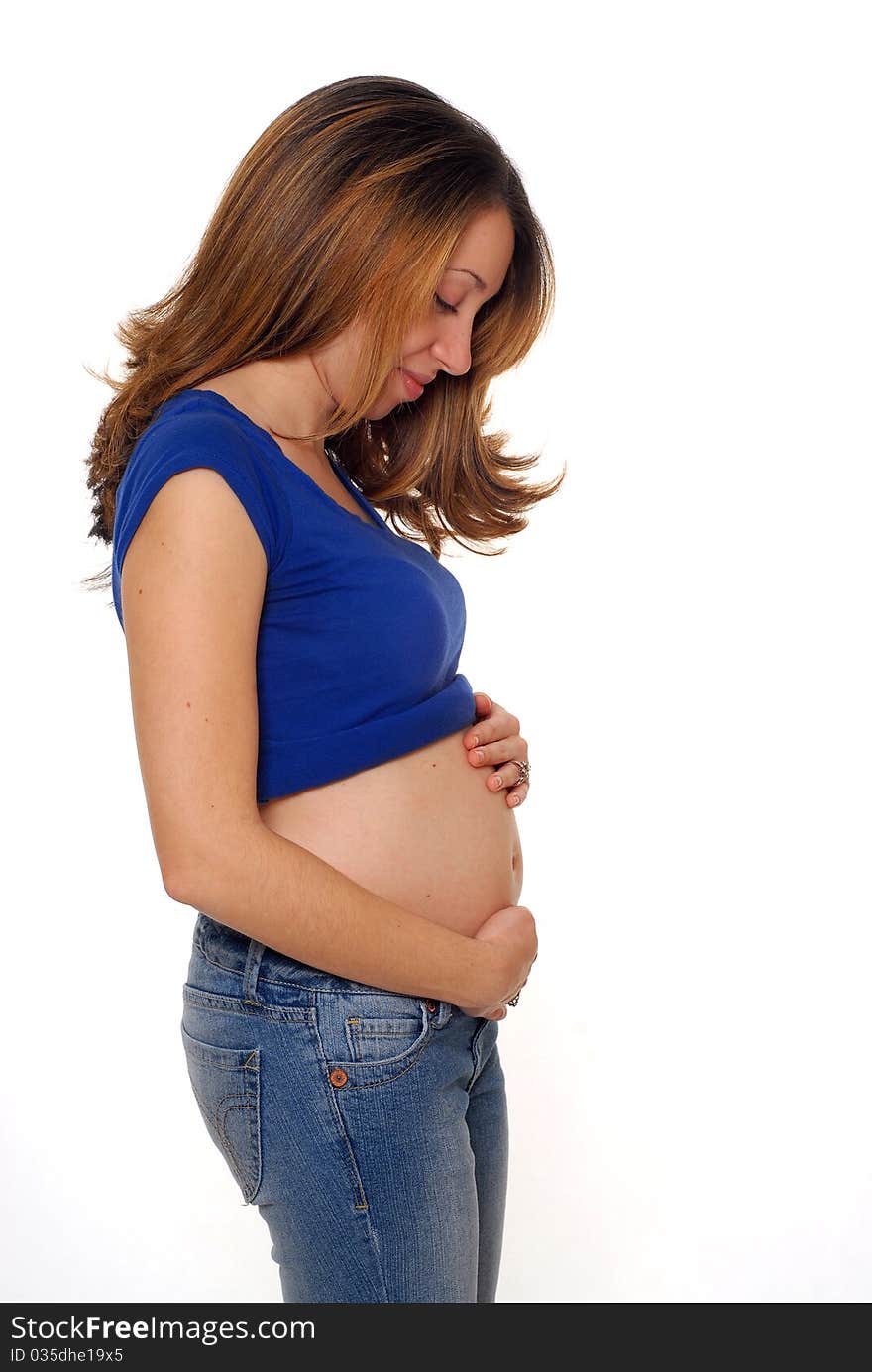 Young pregnant hispanic woman touching her small belly. Young pregnant hispanic woman touching her small belly