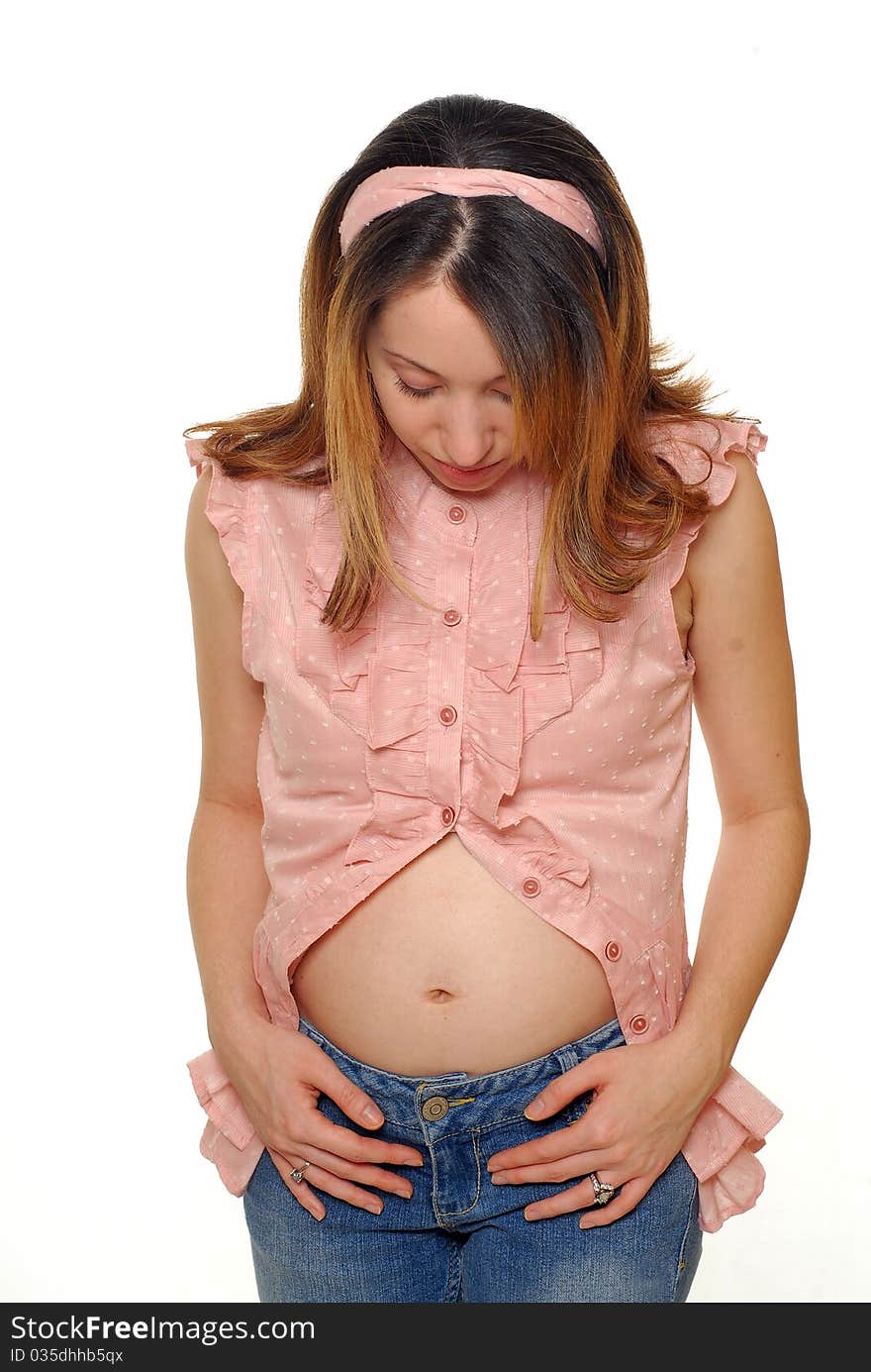 Young pregnant hispanic woman touching her small belly. Young pregnant hispanic woman touching her small belly