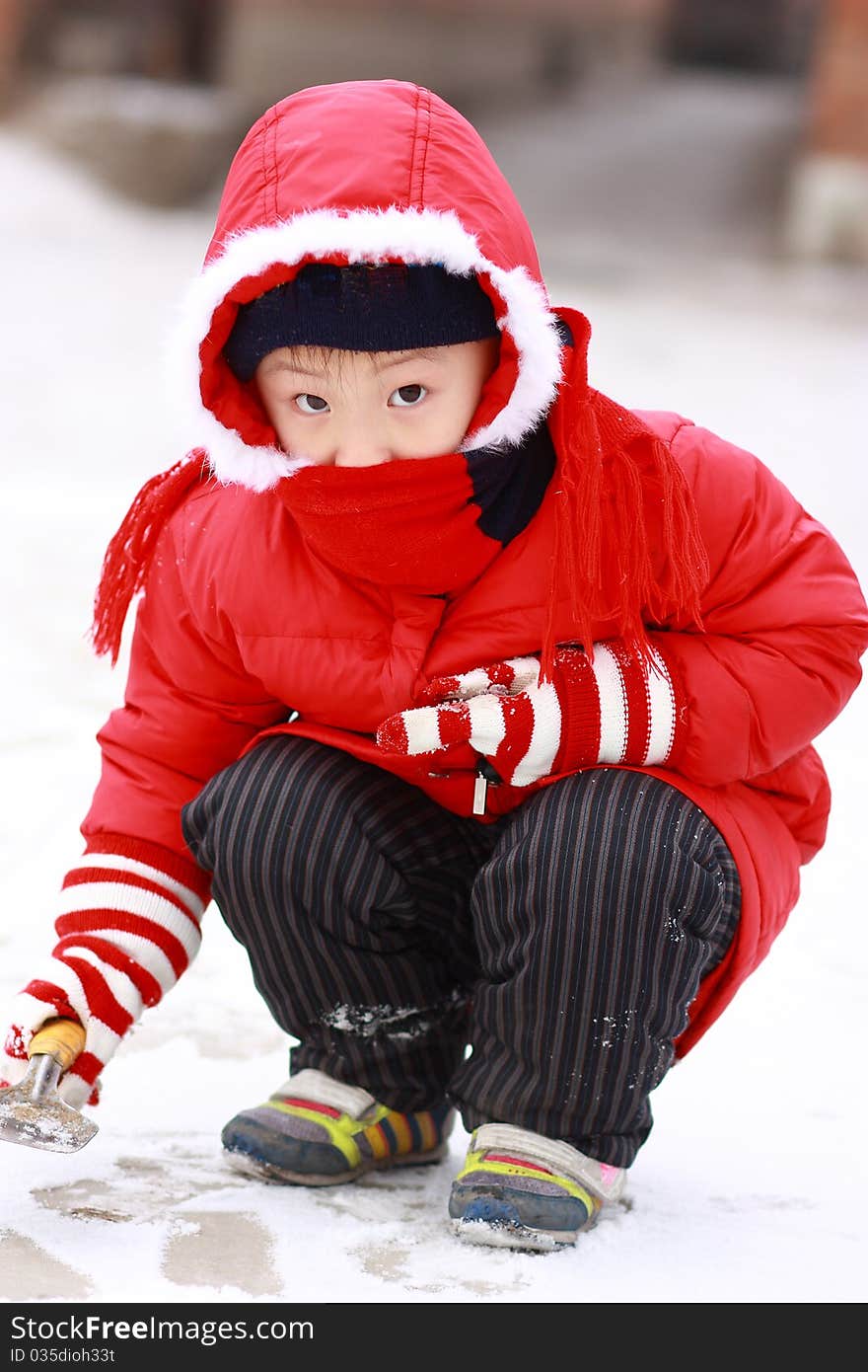 Asian boy is playing snow