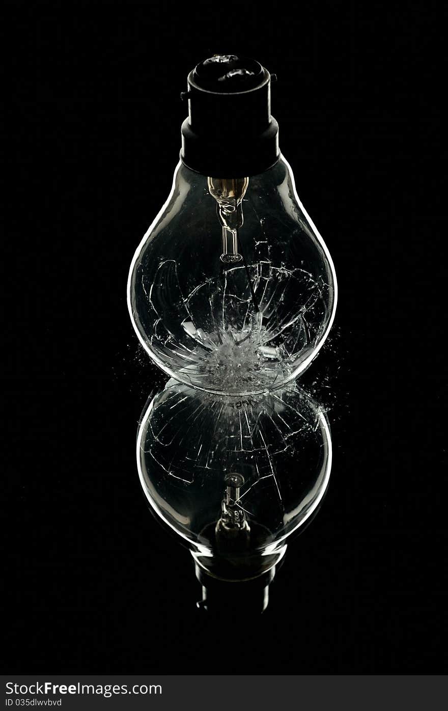 A lightbulb smashing onto a mirror. A lightbulb smashing onto a mirror