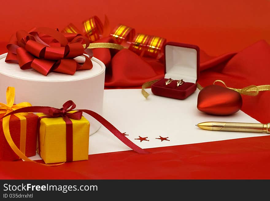 Box with a gift on a red fabric still life