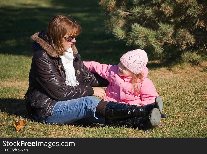 Mum with a daughter in autumn park outdoor